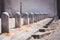 Long line of fixed concrete bollards in the city. Stairs and perspective