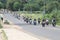 Long line of motorbikes travelling through city streets