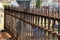 Long line of rusty spikes on metal fencing