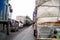 long line of stuck traffic with cars trucks and bikes on a narrow road as the road is blocked by farmers near jaipur