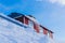 Long and massive icicles hanging from the roof of an old building