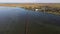 A long narrow bridge over a large lake or estuary. Drone view