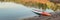 Long and narrow racing stand up paddleboard on a calm mountain lake