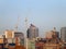 A long panoramic view of leeds showing the town hall offices apartments and skyscrapers with construction cranes with sunlit blue