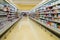 Long passage with food products for sale, exposed in refrigerators and shelves in Auchan supermarket