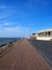 The long pedestrian walkway at the top of the north promenade in blackpool showing the seating and shelters along the coastline