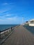 The long pedestrian walkway at the top of the north promenade in blackpool showing the seating and shelters along the coastline