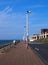 The long pedestrian walkway at the top of the north promenade in blackpool showing the seating and shelters along the coastline ir