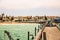 Long pier, walking people, residential houses on coastline of Swakopmund