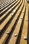 Long planks horizontal, distant perspective with iron rivets in the sunlight