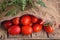 Long plum tomatoes on wooden table. Heap of fresh tomatoes