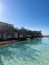 Long pool with clear water and a pebbly bottom near the terraces with columns. Hotel Amanzoe, Greece