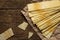 Long potato chips on old wooden table.