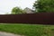 Long private brown metal fence outside