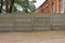 Long private concrete gray fence on a rural street