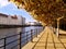 Long promenade along Berlin Landwehrkanal Landwehr Canal with colorful trees and modern architecture on a sunny autumn day.