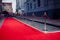 Long red carpet between rope barriers on entrance.