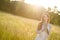 Long red hair woman in romantic sunset meadow