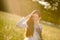 Long red hair woman in romantic sunset meadow