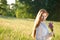 Long red hair woman in romantic sunset meadow