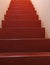 Long red staircase rising to infinity