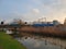 Long reed grass reflecting in the water of the ring canal Zuidplaspolder in Nieuwerkerk aan den IJssel in the Netherlands with rai