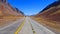 A long road with mount aconcagua in the background