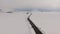 Long road stretches through the snowy landscape