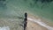 Long, rocky wave breaker on the beach with calm waves crashing against it on a Summer`s day at Point Lonsdale, Mornington