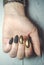 Long round nails with black matte gel polish and gold design.