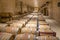 Long rows of wooden barrels filled with maturing wine in a bodega near Valencia, Spain