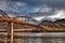 Long rusted bridge looking up from the waterâ€™s edge