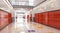 Long school corridor with red lockers