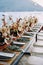 Long set table with holiday menus on plates next to bouquets of flowers stands by the sea