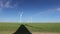 Long shadow under windmill, large wind power turbines spinning to generating clean, green, renewable energy