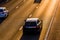 Long shadows of car traffic on uk motorway at sunset in england