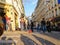 Long shadows on cobbles street and tourists on street corner in Montmartre district