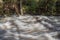 Long shadows over rushing flood waters in the Great Smoky Mountains, space for text