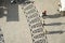 Long shadows of people on a square with pattern of paving stones in Lisbon