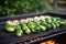 long shot of a bbq grill filled with brussels sprouts