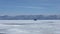 Long shot: a car with a bottom on an air cushion glides on the ice of frozen Lake Baikal.