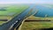 Long Shot of Cargo Ship Crossing an Aqueduct on Peaceful Dutch Flat Landscape - Friesland, The Netherlands 4K Drone Footage