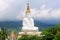 Long shot of five sitting white Buddhas and the foggy hills behind the Buddha at Pha Sorn Kaew, in Khao Kor, Phetchabun, Thailand.