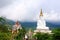 Long shot of five sitting white Buddhas and the foggy hills behind the Buddha at Pha Sorn Kaew, in Khao Kor, Phetchabun, Thailand.