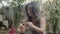 Long shot of focused woman burning palo santo while doing yoga