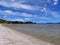 Long shot of Kawakawa Bay with pebbles on low tide seashore in Auckland, New Zealand
