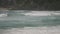 Long shot of surfers riding waves at greenmount on the gold coast of queensland