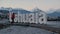 Long shot tourist taking pictures on Ushuaia sign and mountains on background