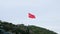 Long shot of turkish national red flag waving in wind on the hill