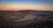 Long sinuous Road in the middle of the Valley of Fire at Sunset